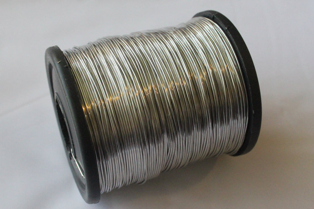 Spool of solder wire on a white background