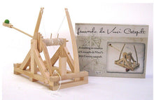 Load image into Gallery viewer, An assembled working wooden replica of Leonardo da Vinci&#39;s catalpult in front of the box.
